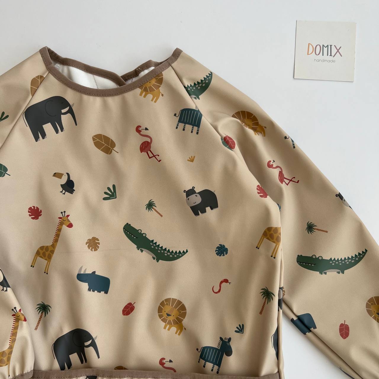 Children's long-sleeve shirt with animal patterns on a plain background