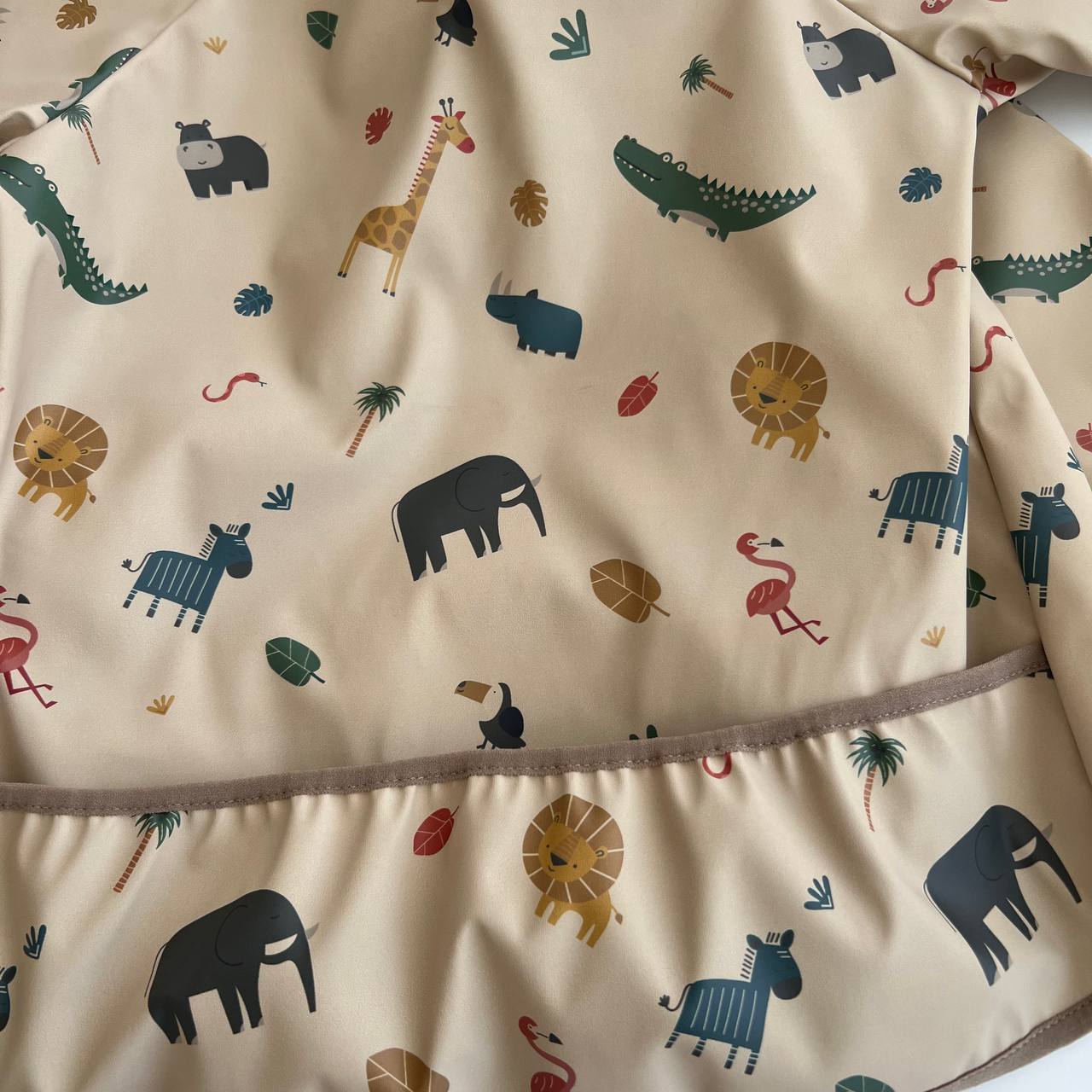 Fabric with colorful animal pattern on a beige background
